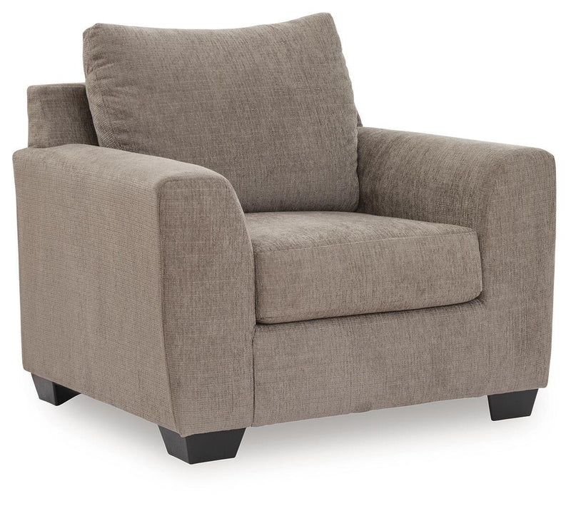 Benchcraft® arm chair with plush fabric upholstery and modern design, featuring a supportive back and comfortable armrests.