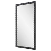Black industrial wall mirror by Uttermost with a sturdy metal frame, showcasing a modern, minimalist design.
