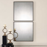 Pair of black antiqued square wall mirrors by Uttermost, featuring a vintage style and decorative square frames.