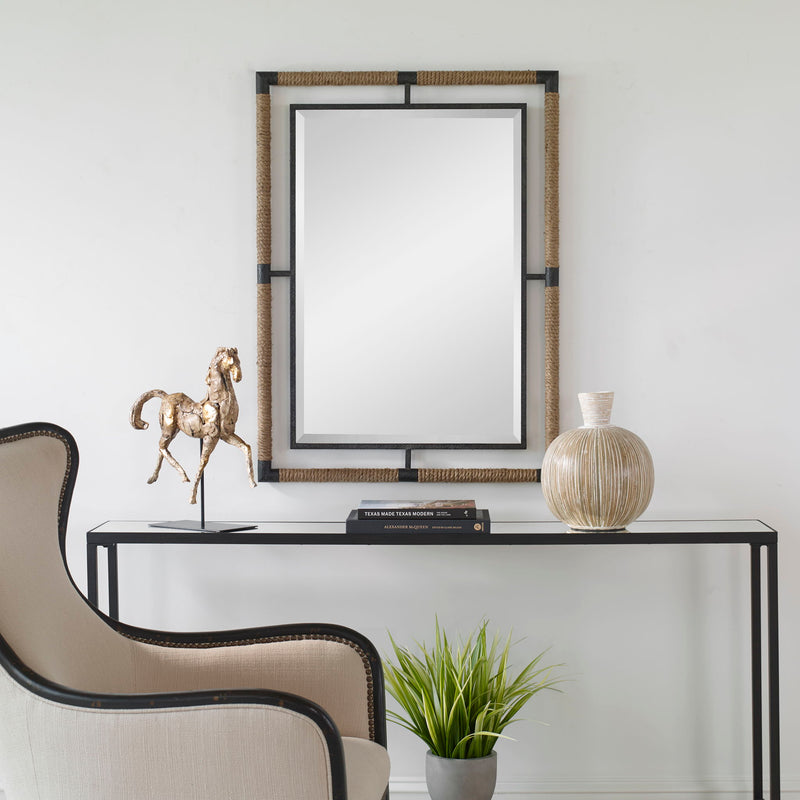 Uttermost Melville iron and rope wall mirror in light brown with a rustic, nautical design featuring a round shape and textured frame.