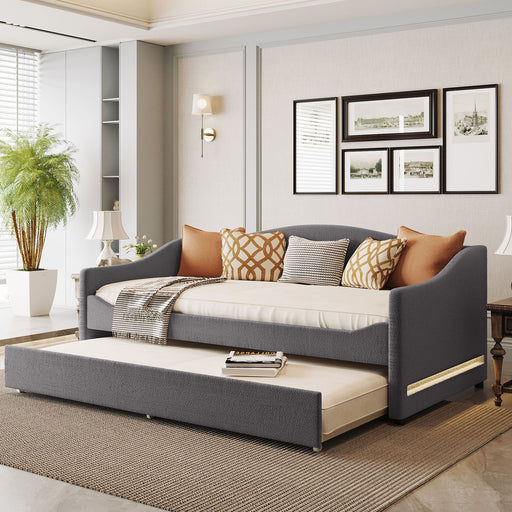 Halcyon Home upholstered daybed with light-colored fabric, featuring a built-in trundle bed and soft cushioning for relaxing.