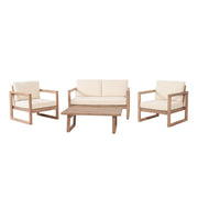 Noble House 4-piece acacia wood outdoor patio furniture set with beige cushions, includes chairs and coffee table for porch or backyard.