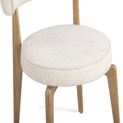 Cream fabric TOV Furniture Nikita dining side chair with a sleek, modern design and wooden legs.