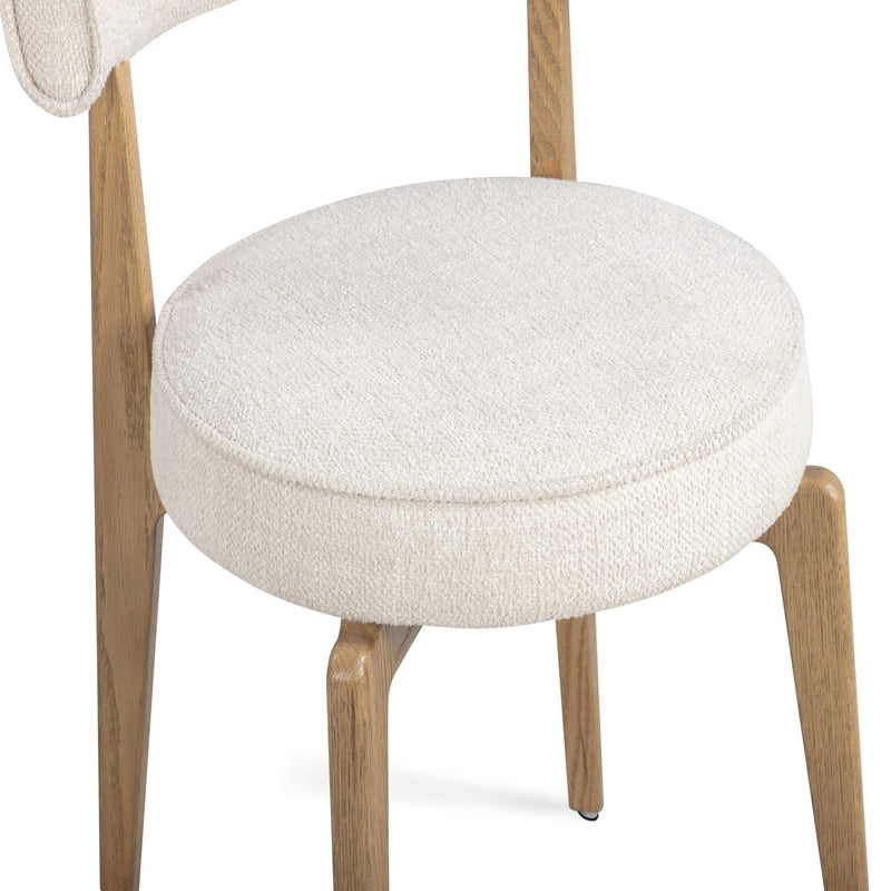 Cream fabric TOV Furniture Nikita dining side chair with a sleek, modern design and wooden legs.