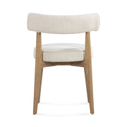 Cream fabric Nikita side dining chair by TOV Furniture with a sleek, modern design and wooden legs.