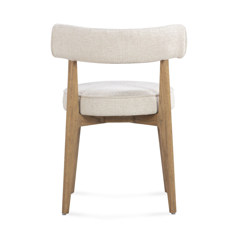 Cream fabric Nikita side dining chair by TOV Furniture with a sleek, modern design and wooden legs.