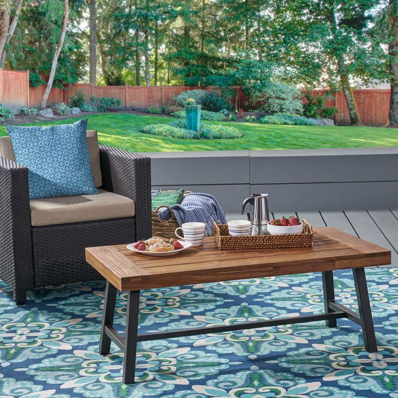 Noble House Carlisle industrial coffee table with natural wood finish and slat panel design, modern and sturdy living room furniture.