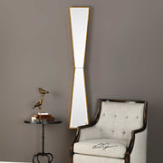 Gold mirror wall decor by Uttermost featuring a sleek, reflective surface and a contemporary mirror design.