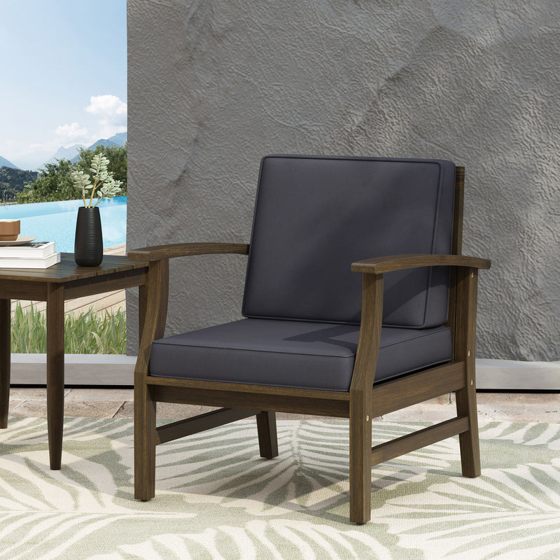 Dark gray Noble House outdoor club chair with slat panel design and water-resistant cushion, perfect for patio or garden seating.