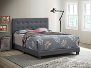 Glory Furniture Caldwell upholstered bed with a padded headboard and neutral fabric, showcasing a stylish bedroom centerpiece.
