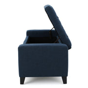 Noble House Guernsey storage ottoman with tufted top, beige fabric, and sturdy wooden legs for versatile living room or bedroom storage.