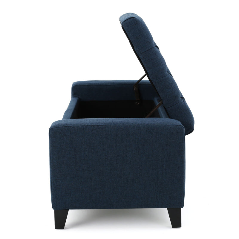 Noble House Guernsey storage ottoman with tufted top, beige fabric, and sturdy wooden legs for versatile living room or bedroom storage.