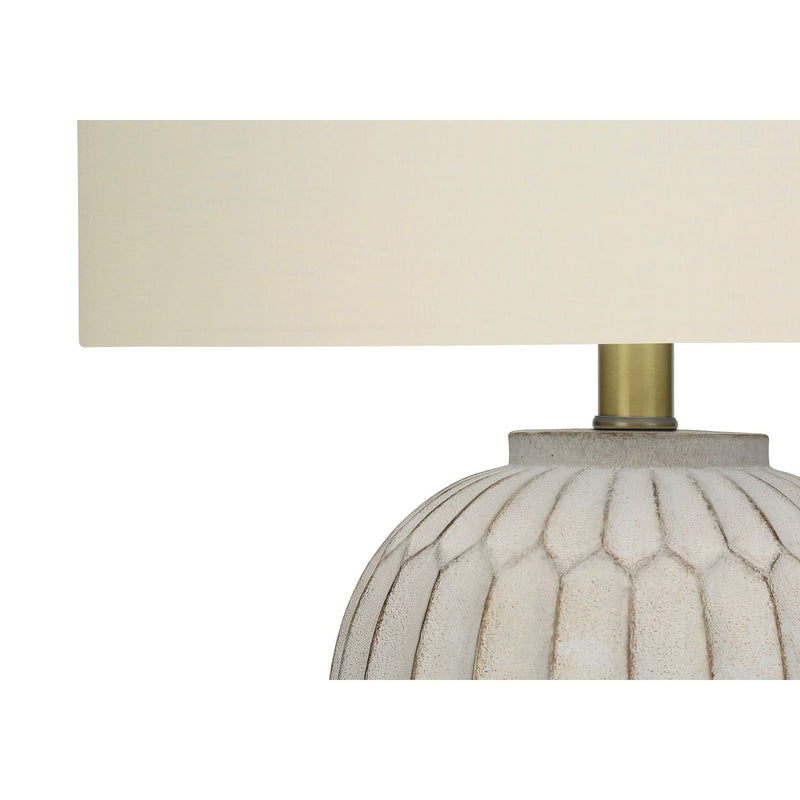 Cream-colored 8th Street transitional table lamp with a classic design, featuring a rounded base and fabric shade.