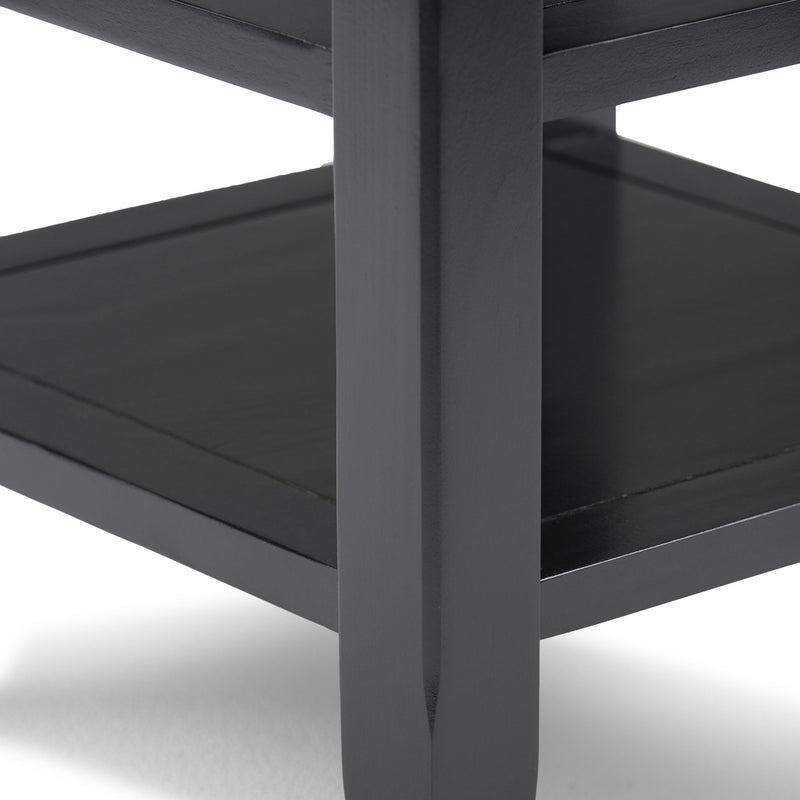 Handcrafted Acadian end table by Simpli-Home with a wooden finish, featuring a simple rectangular top and sturdy legs.