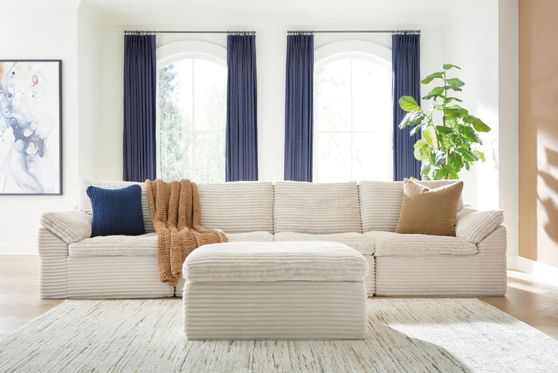 Ivory Fannin 4-piece sectional with matching ottoman by Signature Design Ashley, featuring plush cushions and modern design.