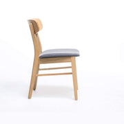 Set of two Noble House dining chairs with cushioned seats, featuring wooden frames and upholstered beige cushions.