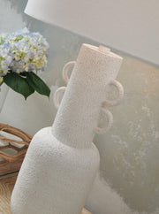 Distressed white metal table lamp from Signature Design by Ashley, featuring a classic design and a sturdy base.