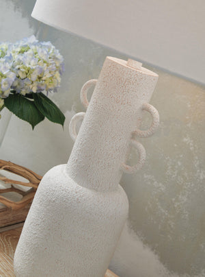 Distressed white metal table lamp from Signature Design by Ashley, featuring a classic design and a sturdy base.