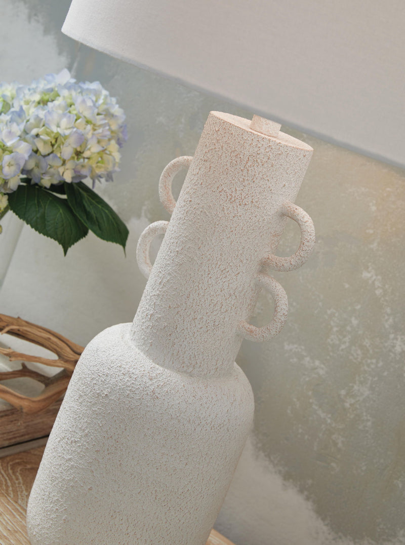 Distressed white metal table lamp from Signature Design by Ashley, featuring a classic design and a sturdy base.