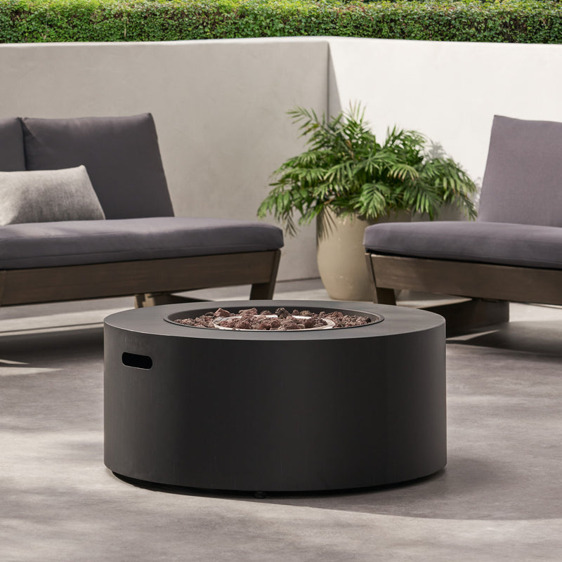 Round iron fire pit from Noble House with 40,000 Btu, showcasing a sturdy metal design and open top for outdoor fires.