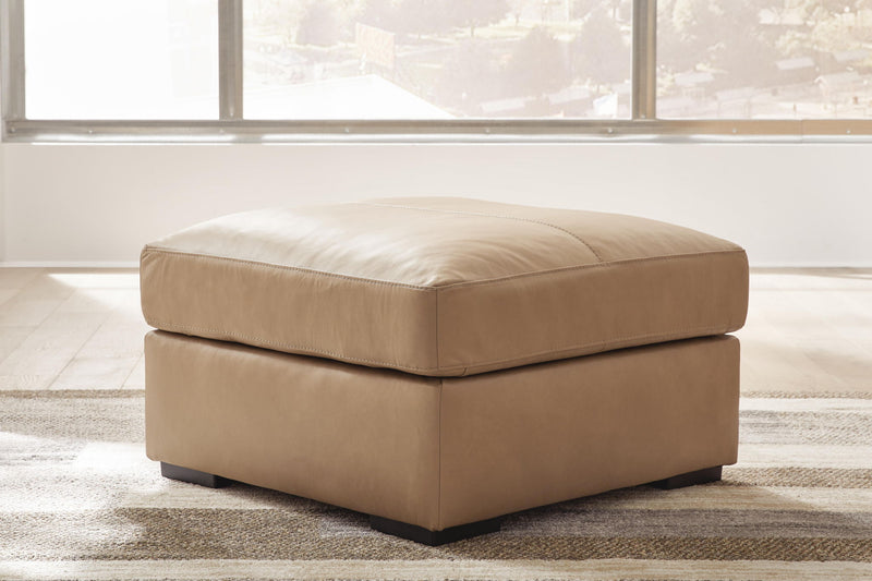 Signature Design by Ashley Bandon oversized accent ottoman in toffee, featuring a plush cushioned top and sturdy wooden legs.