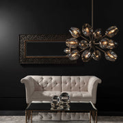Uttermost Chet 12-Light Sputnik chandelier in light brown with metal and glass globe accents, hanging with a modern design.