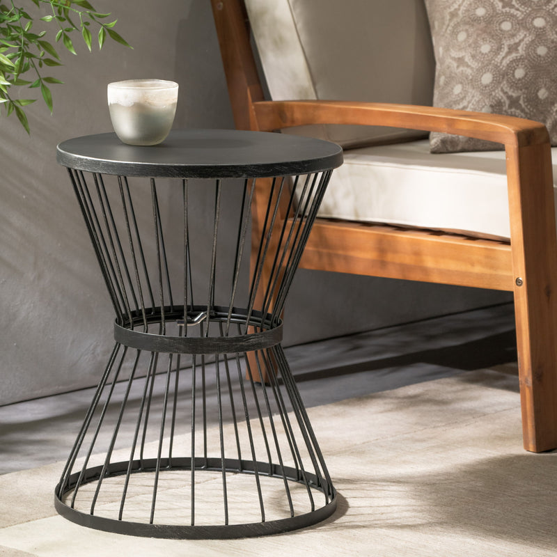 Noble House Lassen outdoor side table with modern hourglass design, featuring sleek metal frame and compact surface for outdoor decor.