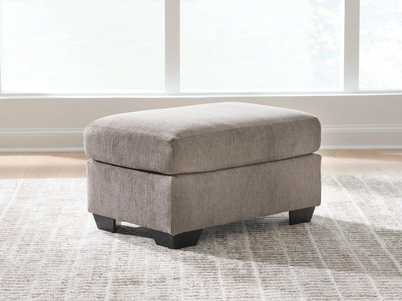 Benchcraft® upholstered Ottoman from Loreo collection, showing soft fabric upholstery and a cushioned top for seating or decor.