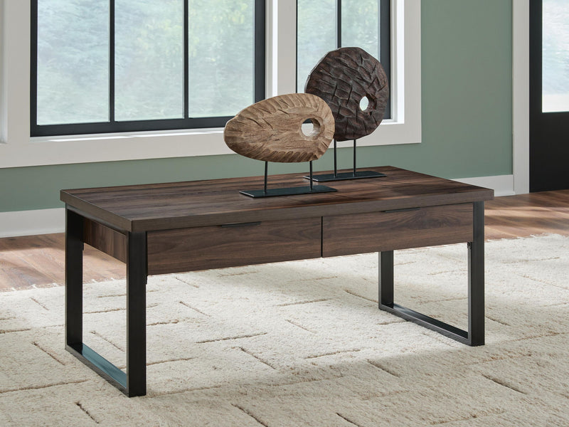 Signature Design by Ashley Wickman Falls rectangular cocktail table with a sleek wooden surface and modern design.