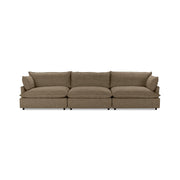 Classic Home Caplan modular sectional in neutral fabric, showing its L-shaped design with plush cushions and wooden legs.