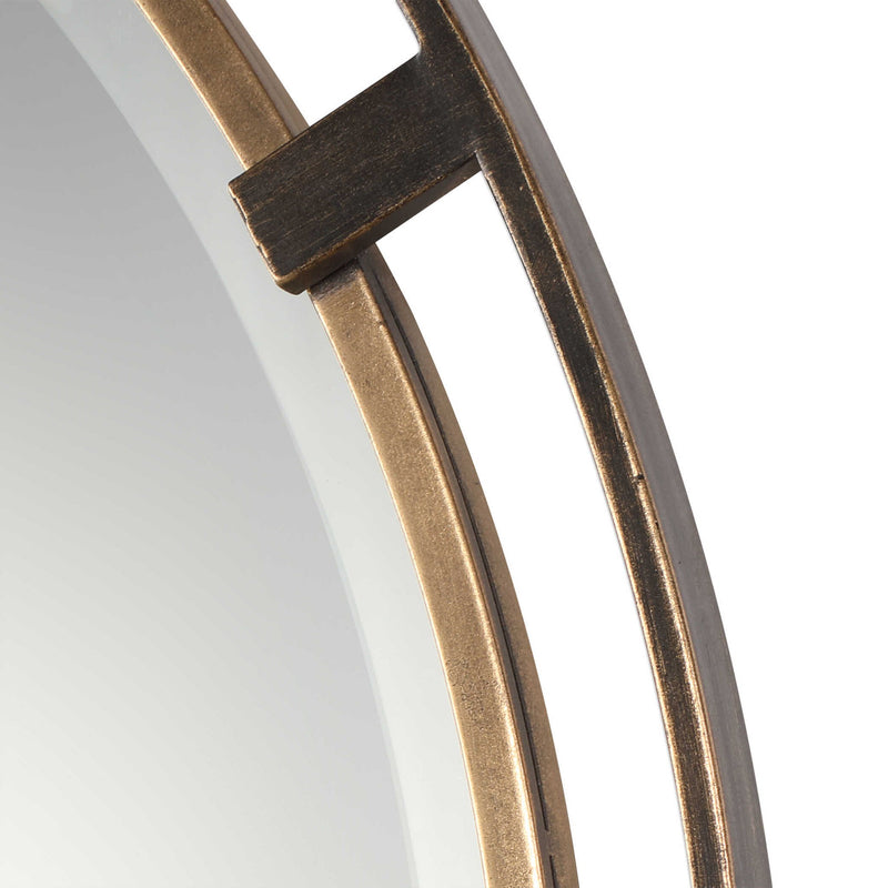 Uttermost Carrizo round wall mirror with bronze finish, featuring a sleek, modern design and a smooth circular frame.