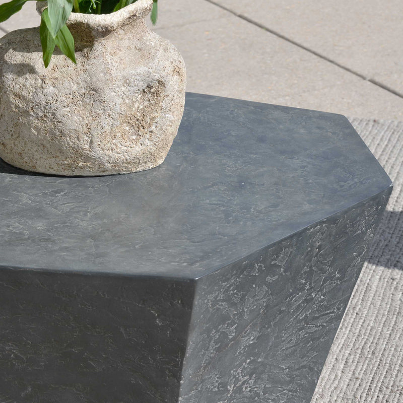 Uttermost Parra outdoor coffee table with a sleek, modern design and metal frame, shown in a stylish outdoor setting.