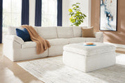 Ivory Fannin 4-piece sectional with matching ottoman by Signature Design by Ashley, showcasing plush cushions and modern style.