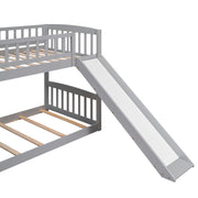 Gray DreamHaus twin over twin bunk bed with stairway, two drawers, and slide, showcasing the sturdy frame and built-in storage.