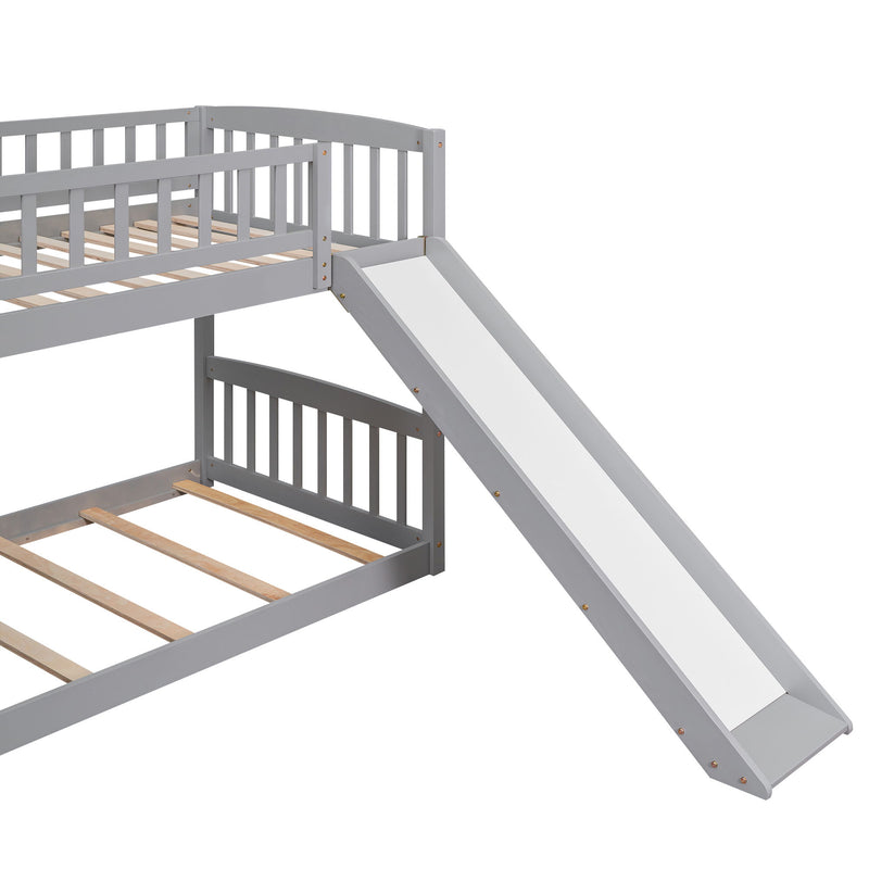 Gray DreamHaus twin over twin bunk bed with stairway, two drawers, and slide, showcasing the sturdy frame and built-in storage.