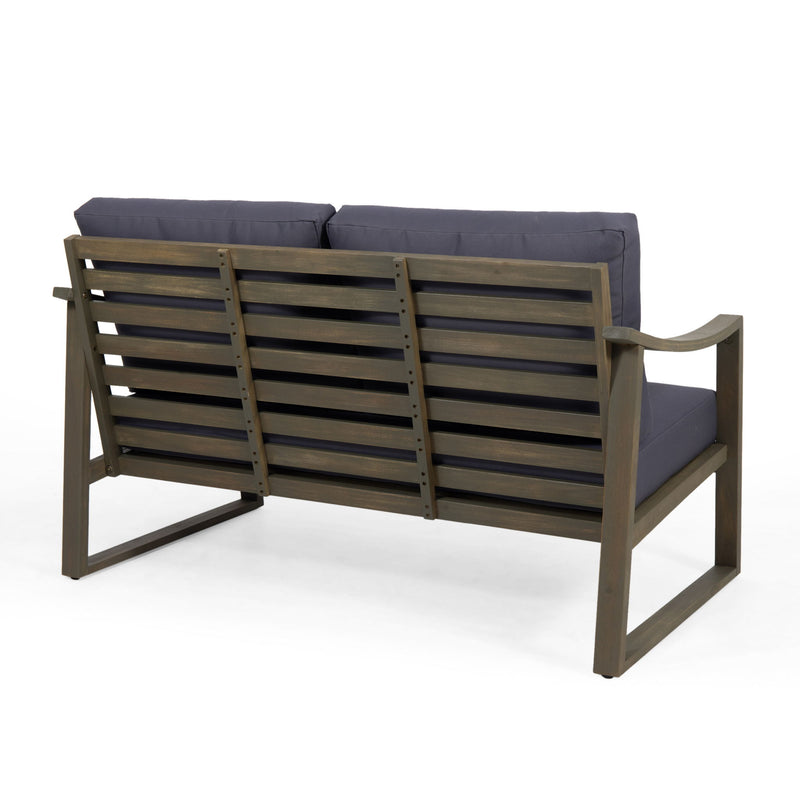 Noble House Samwell outdoor 2-piece coffee table and loveseat set with woven rattan frames and neutral cushions.