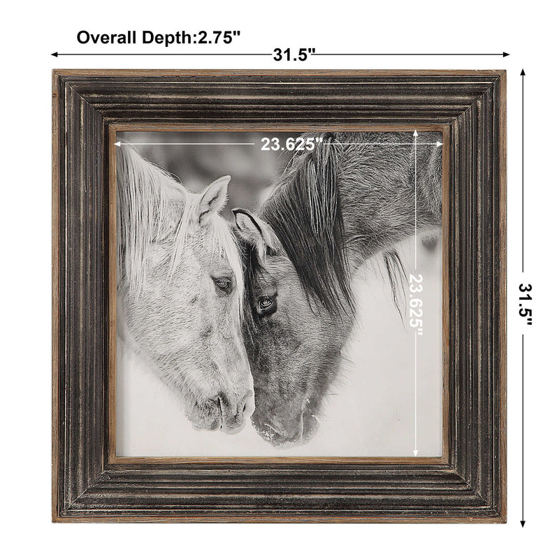 Framed print of black and white horses by Uttermost featuring dark brown accents, showcasing detailed horse artwork.