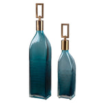 Set of two teal glass bottles by Uttermost, decorative vases with smooth curves and transparent teal color for stylish home decor.