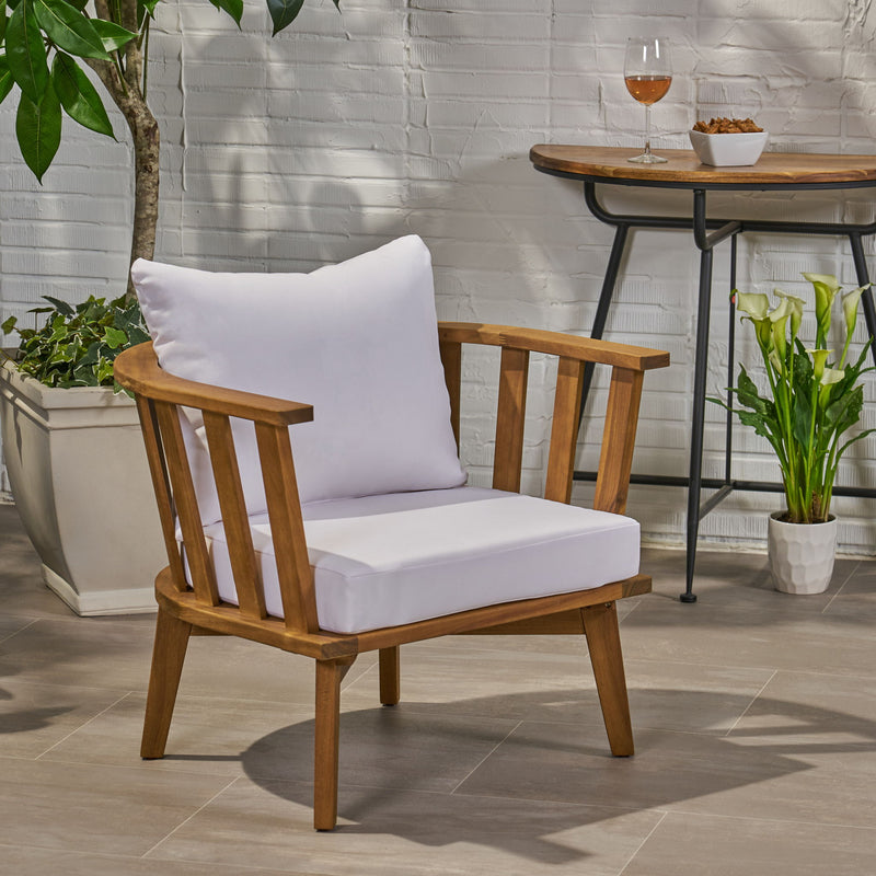Noble House outdoor arm chair with curved backrest and white frame, designed for comfortable outdoor seating.