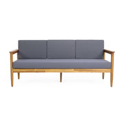 Dark gray outdoor 3-seater sofa with cushions made of teak acacia wood by Noble House, perfect for patio seating.