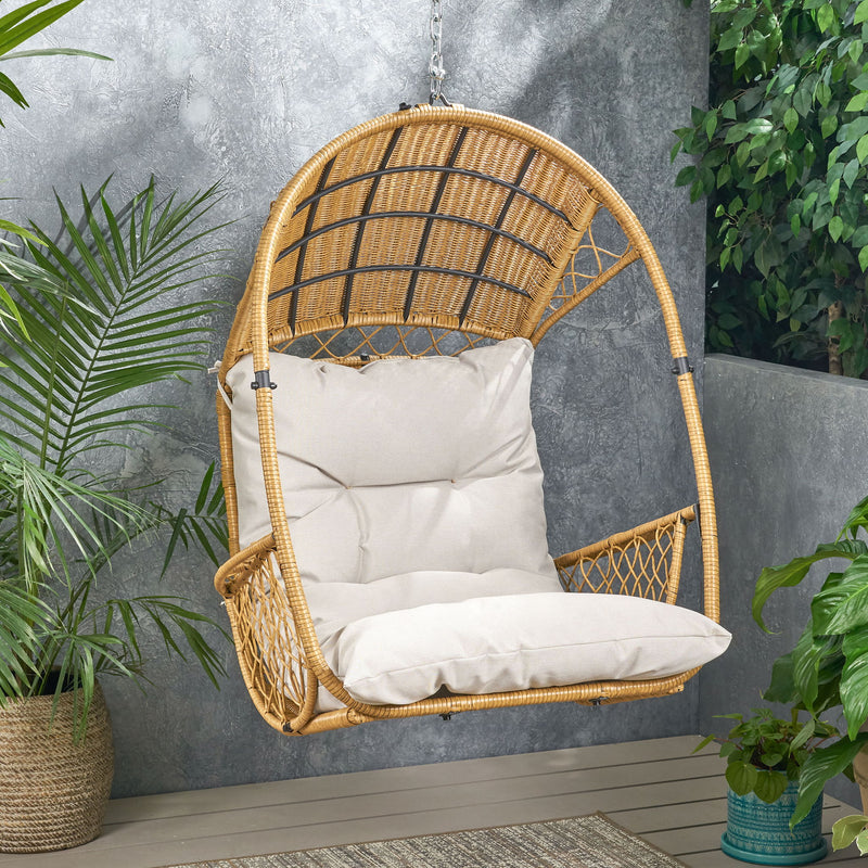 Wicker hanging chair with cushion from Noble House, featuring a cozy woven design and plush seating for outdoor relaxation.