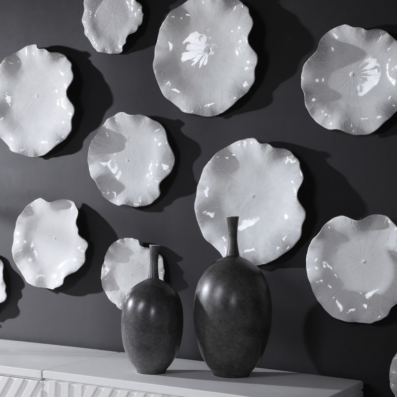 Set of three ceramic wall decor pieces by Uttermost, featuring modern abstract designs for stylish home wall accents.