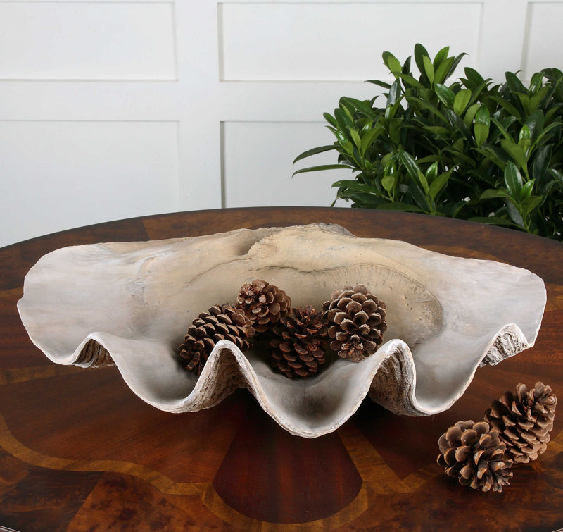 Beige clam shell bowl by Uttermost, decorative ceramic plate with a shell design, ideal for coastal-inspired table decor.