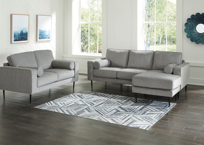 Signature Design by Ashley Hazela living room set with stationary sofas and loveseats featuring plush cushions and stylish upholstery.