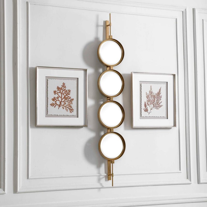 Uttermost wall mirror with a button-style frame, featuring a sleek, modern design perfect for contemporary home decor.