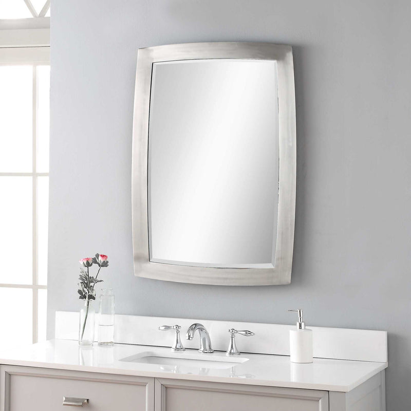 Uttermost Haskill wall mirror with brushed nickel frame, rectangular shape, modern design, hanging on a wall.