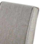 Set of two Classic Home upholstered dining chairs with cushioned seats and high backs, featuring neutral fabric and wooden legs.