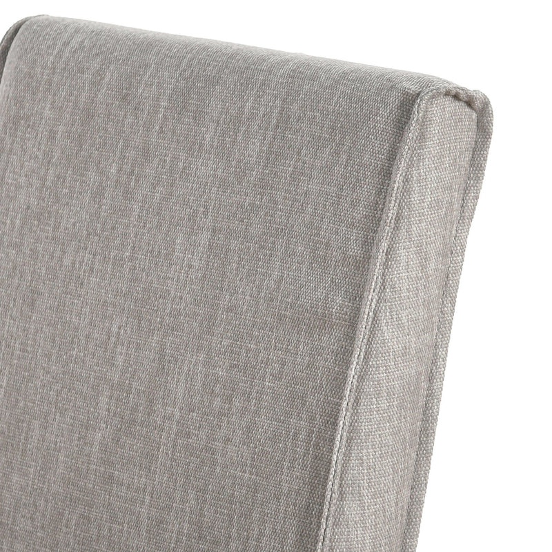 Set of two Classic Home upholstered dining chairs with cushioned seats and high backs, featuring neutral fabric and wooden legs.