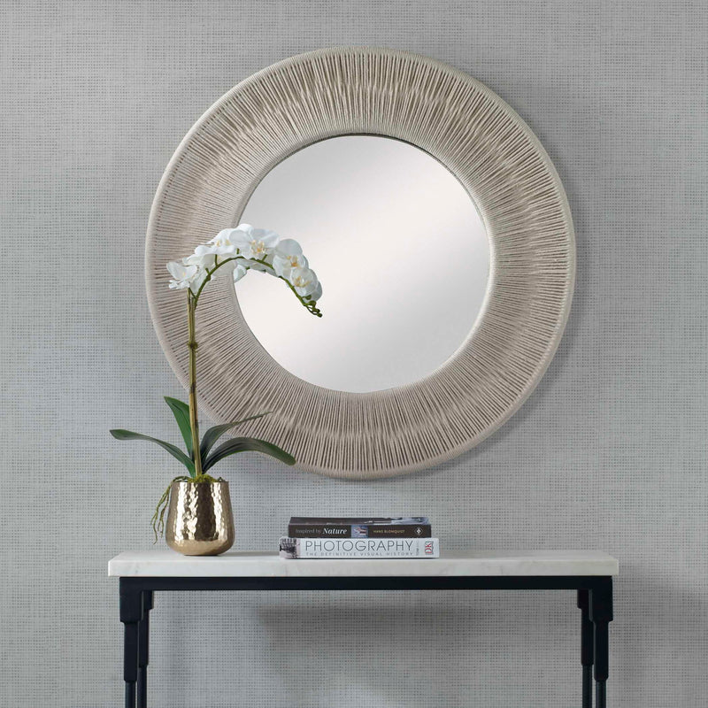 Round wall mirror with a sailor's knot design, by Uttermost, featuring a nautical-inspired decorative frame.