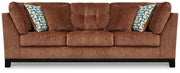 Ashley® Laylabrook plush upholstered sofa with dark wood trim, bold spice color, in a stylish living room setting.